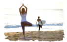 girl doing yoga on beach watching man with surfboard retreat